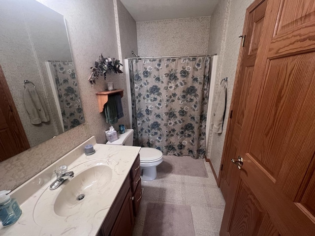 bathroom featuring vanity, curtained shower, and toilet