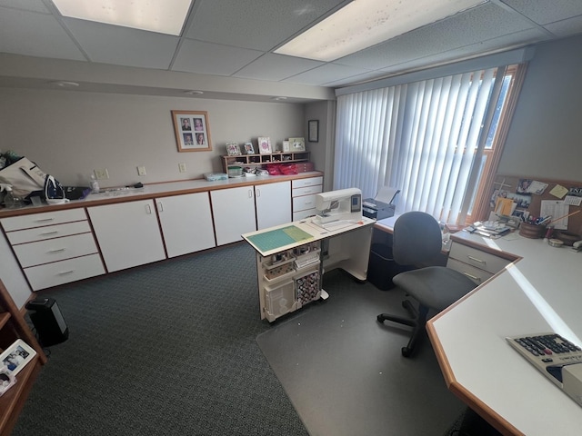 home office featuring carpet and a drop ceiling