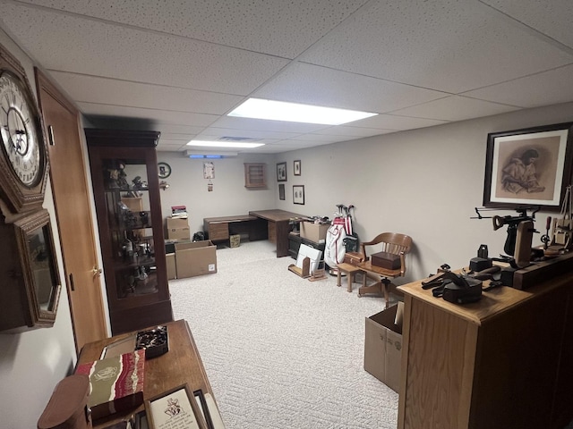 carpeted living room featuring a drop ceiling