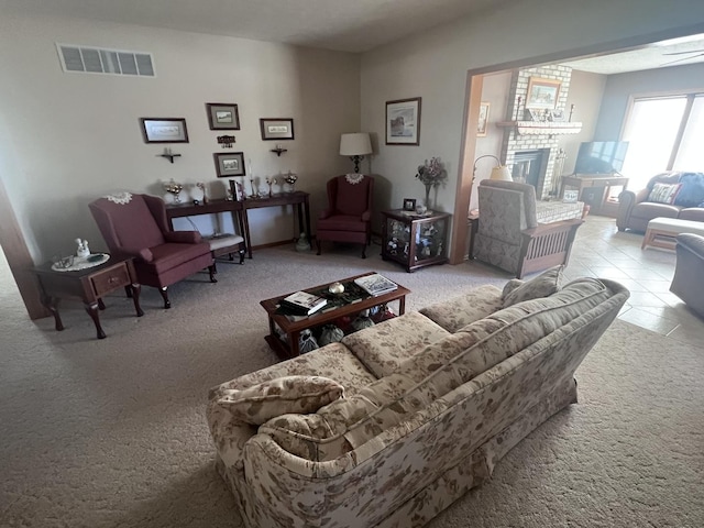 living room featuring light tile patterned floors and a fireplace