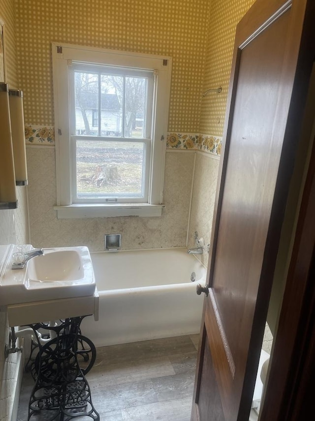 bathroom with a tub to relax in