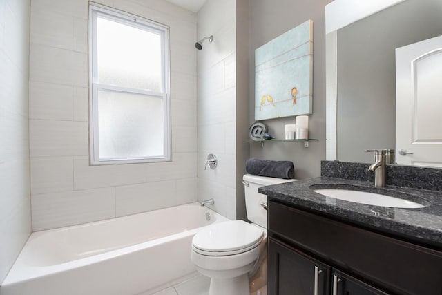 full bathroom featuring tiled shower / bath, vanity, and toilet