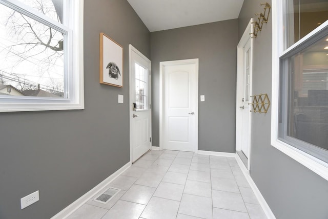 doorway to outside featuring light tile patterned floors