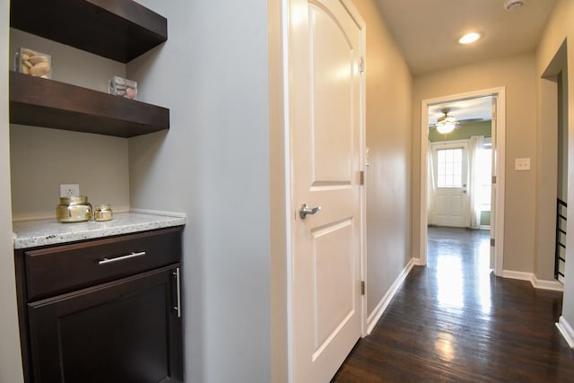 corridor with dark hardwood / wood-style flooring