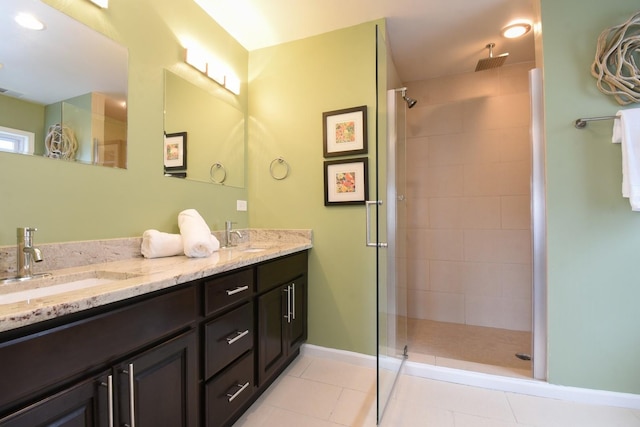 bathroom featuring walk in shower, vanity, and tile patterned flooring