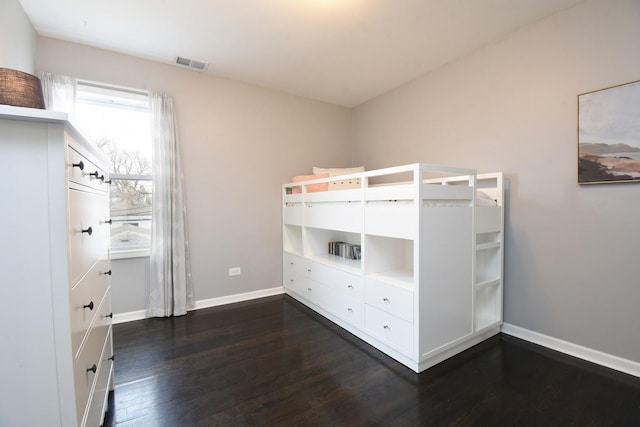 unfurnished bedroom featuring dark hardwood / wood-style floors