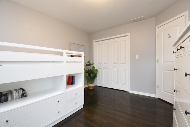 bedroom featuring dark hardwood / wood-style floors and a closet