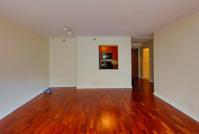 spare room with dark hardwood / wood-style floors