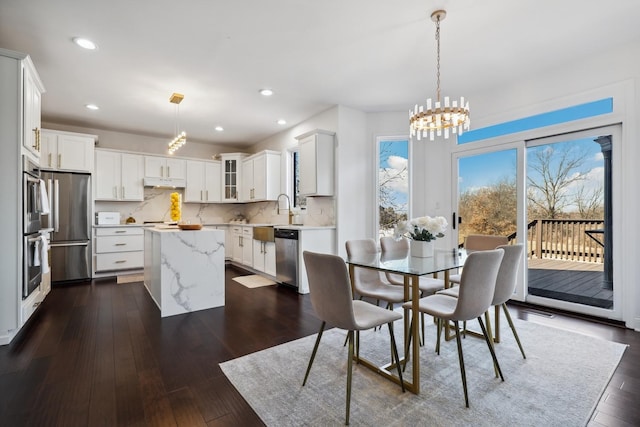 dining room featuring a chandelier, dark wood finished floors, and recessed lighting