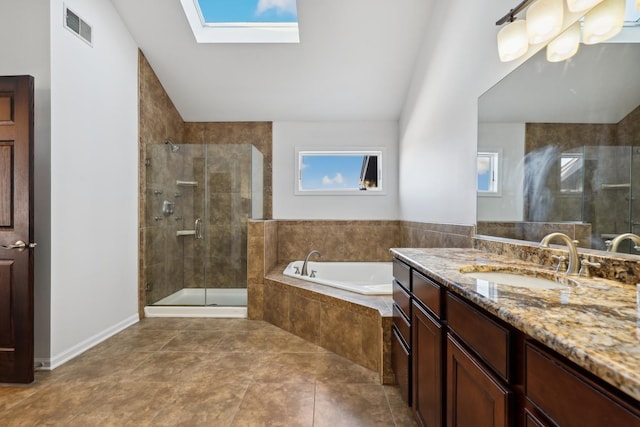 full bathroom featuring a garden tub, visible vents, lofted ceiling with skylight, a stall shower, and vanity