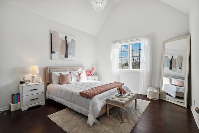 bedroom featuring dark wood-style floors, baseboards, high vaulted ceiling, and a chandelier