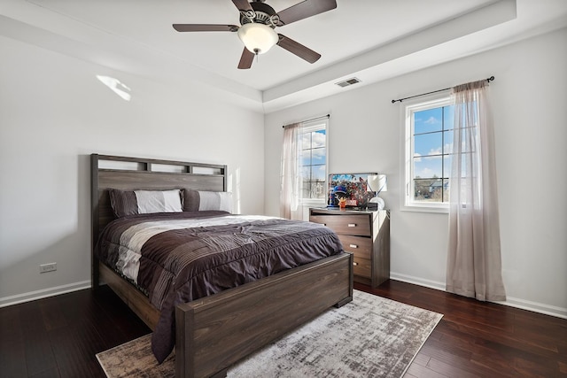 bedroom with visible vents, baseboards, and hardwood / wood-style flooring