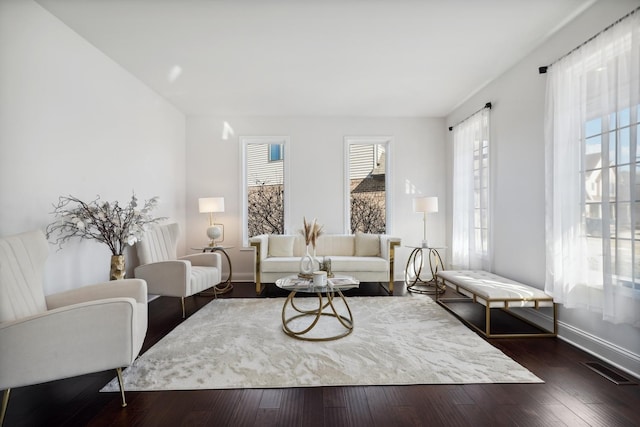 living area with dark wood finished floors and baseboards