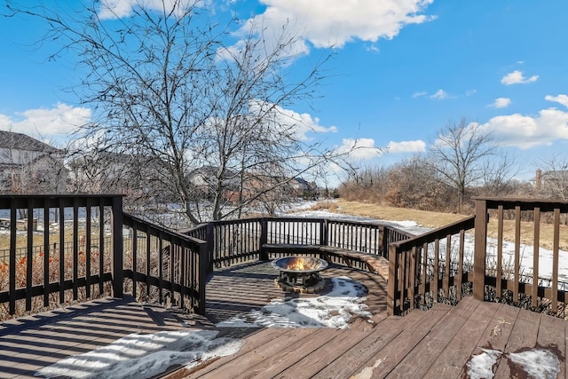 wooden terrace featuring a fire pit