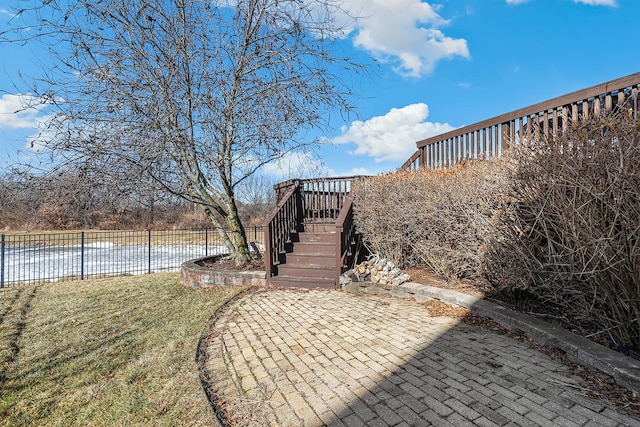 exterior space with a yard, a patio, fence, a wooden deck, and stairs