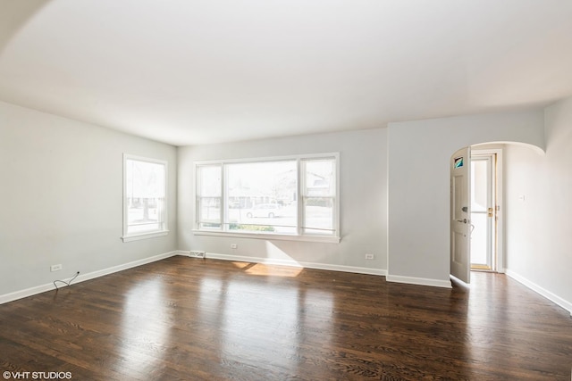 spare room with dark hardwood / wood-style flooring