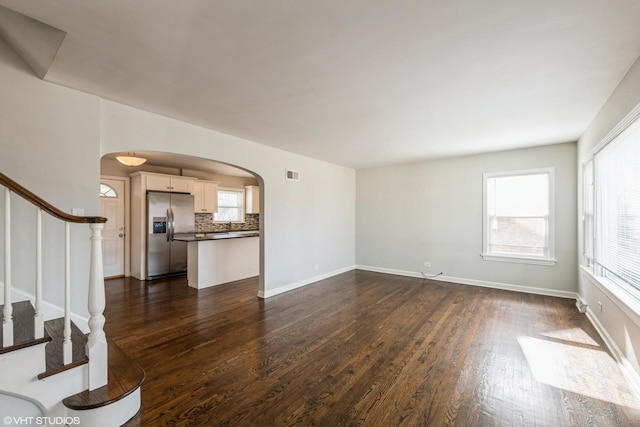 unfurnished living room featuring dark hardwood / wood-style floors