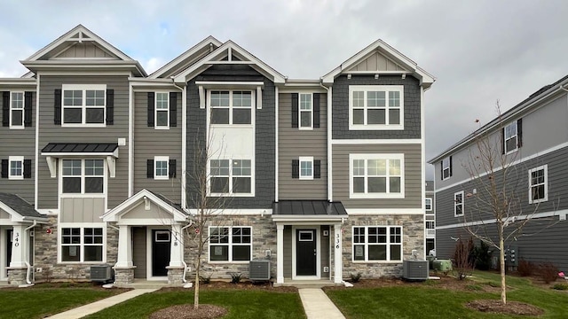 view of front of house featuring central AC and a front lawn