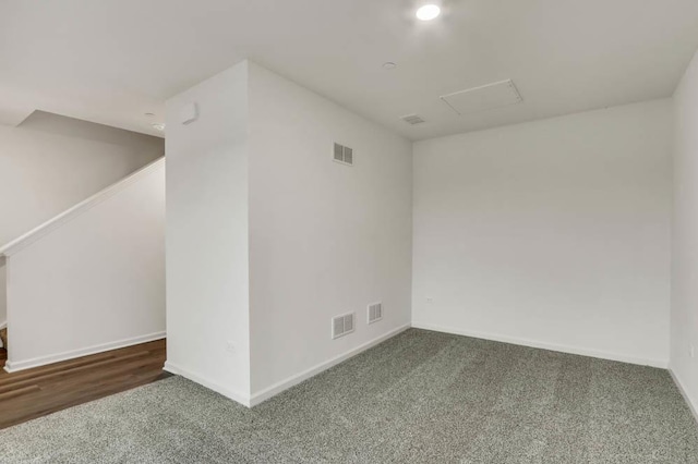 unfurnished room featuring dark colored carpet