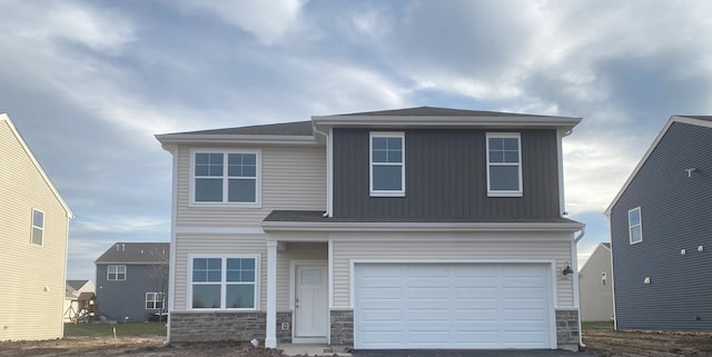 view of front facade featuring a garage, stone siding, and aphalt driveway