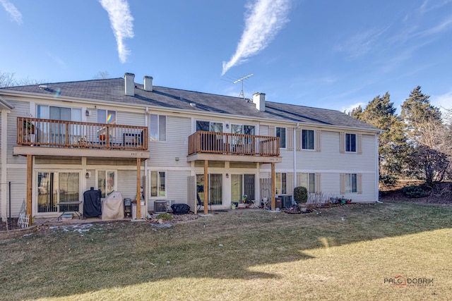 back of property featuring a yard and a balcony