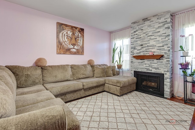 living room featuring a stone fireplace