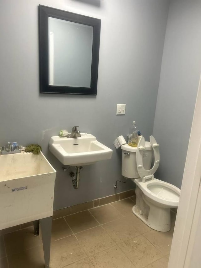 bathroom featuring tile patterned flooring, sink, and toilet