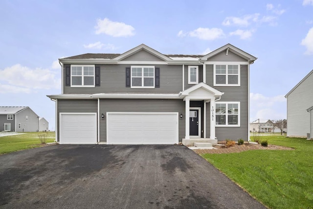 view of front of house featuring a garage and a front lawn