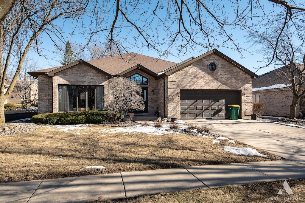 view of front of house featuring a garage and a front lawn