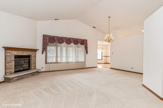 unfurnished living room featuring carpet floors, a glass covered fireplace, a chandelier, and high vaulted ceiling