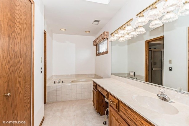 full bathroom with a bath, an enclosed shower, vanity, and visible vents