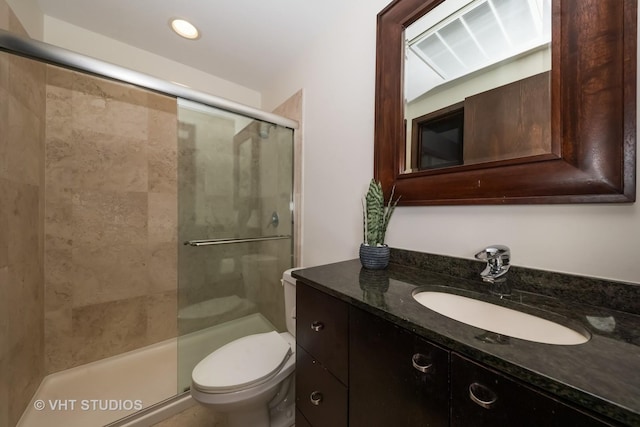 bathroom with vanity, toilet, and walk in shower