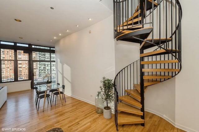 staircase with hardwood / wood-style floors