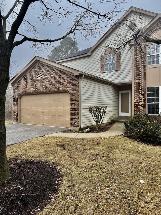 front of property featuring a garage and a front lawn