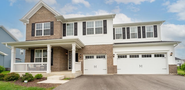 view of front of property featuring a garage and a porch