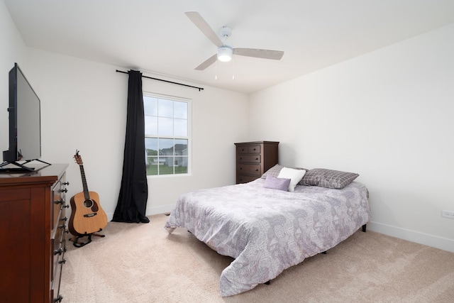 bedroom featuring light colored carpet and ceiling fan