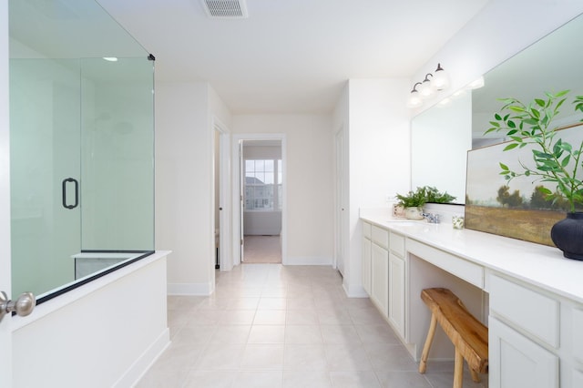 bathroom with vanity, tile patterned floors, and walk in shower