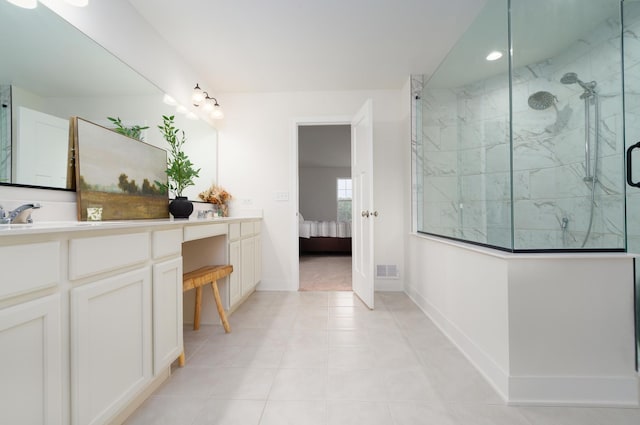 bathroom featuring tile patterned flooring, vanity, and walk in shower