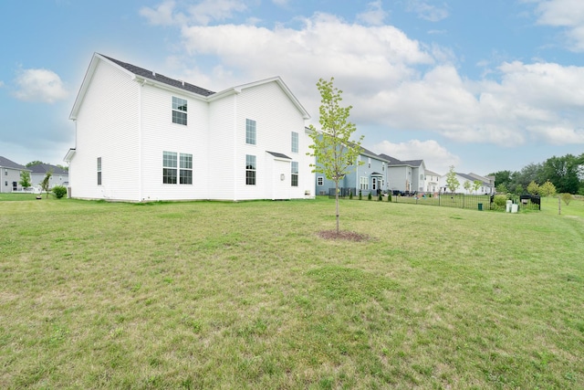 back of house featuring a yard