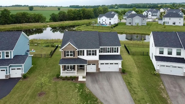 birds eye view of property featuring a water view