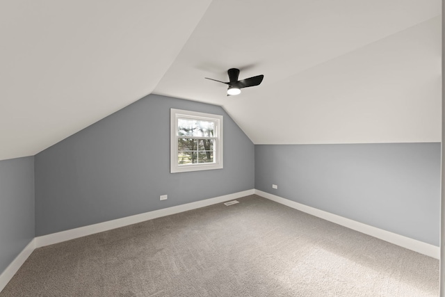 additional living space featuring lofted ceiling, ceiling fan, and carpet