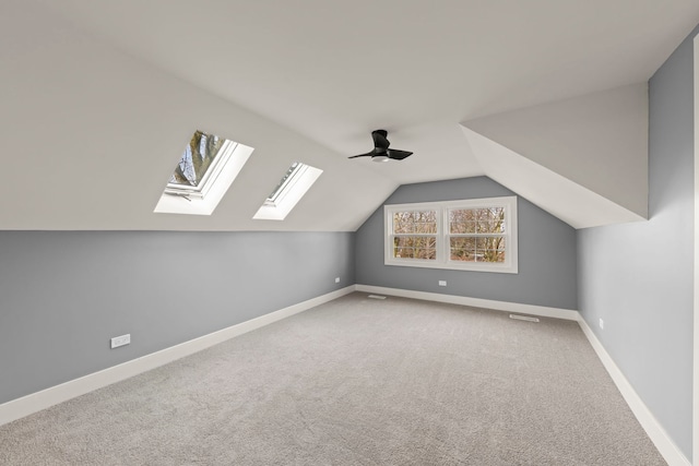 additional living space featuring lofted ceiling, carpet flooring, and ceiling fan