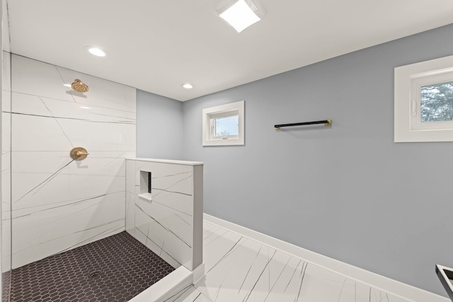 bathroom featuring plenty of natural light and a tile shower