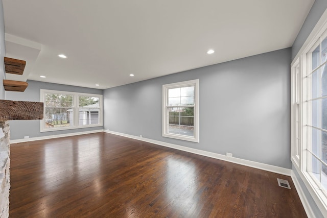 unfurnished living room with dark wood-type flooring