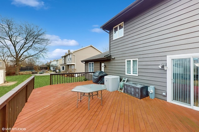 deck featuring a yard and grilling area