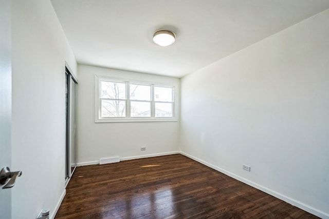 spare room featuring dark hardwood / wood-style floors