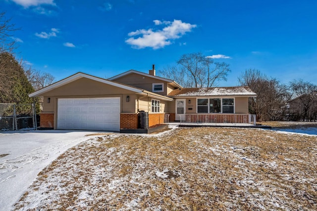 single story home with a garage and covered porch