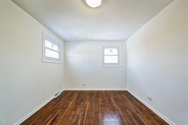 unfurnished room with dark hardwood / wood-style floors