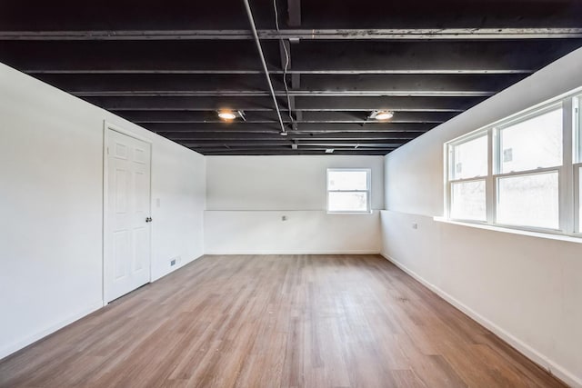 basement featuring hardwood / wood-style floors