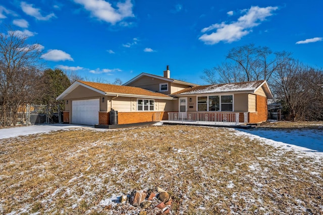 ranch-style home featuring a garage and covered porch